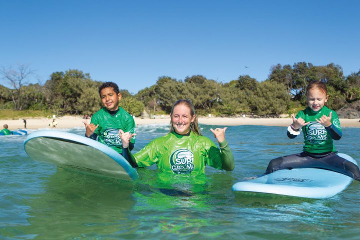 a person riding a surf board on a body of water